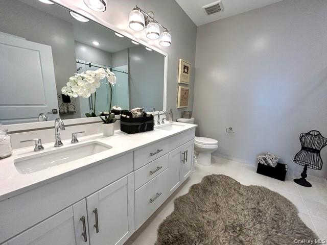 75 East Hoffman Avenue, Unit 2077 Lindenhurst, NY 11757 - Photo 13 of 15 a bathroom with a double vanity sink and a mirror