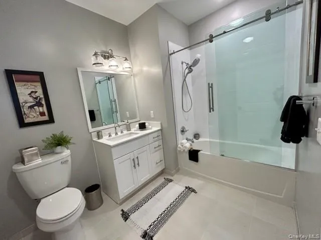 a bathroom with a sink a toilet a mirror a vanity and shower