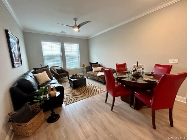 75 East Hoffman Avenue, Unit 2077 Lindenhurst, NY 11757 - Photo 9 of 15 a view of a dining room with furniture window and wooden floor