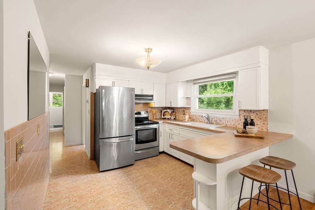 3 Wilson Street Worcester, MA 01604 - Photo 16 of 42 a kitchen with a refrigerator a stove a sink and a refrigerator