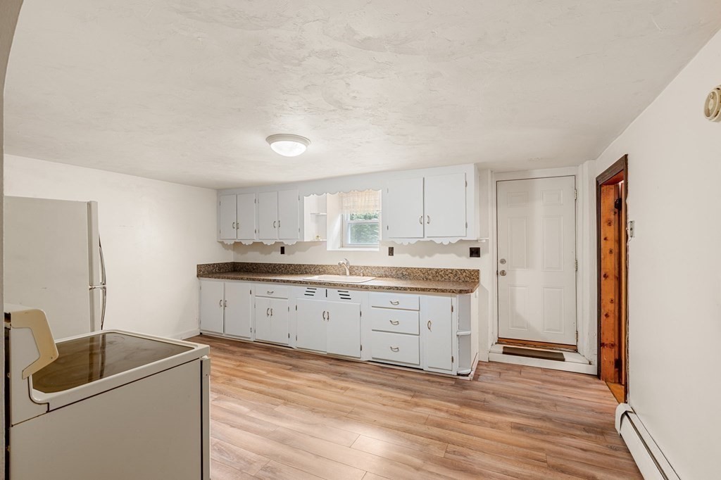 3 Wilson Street Worcester, MA 01604 - Photo 27 of 42 a kitchen with granite countertop a sink cabinets and wooden floor