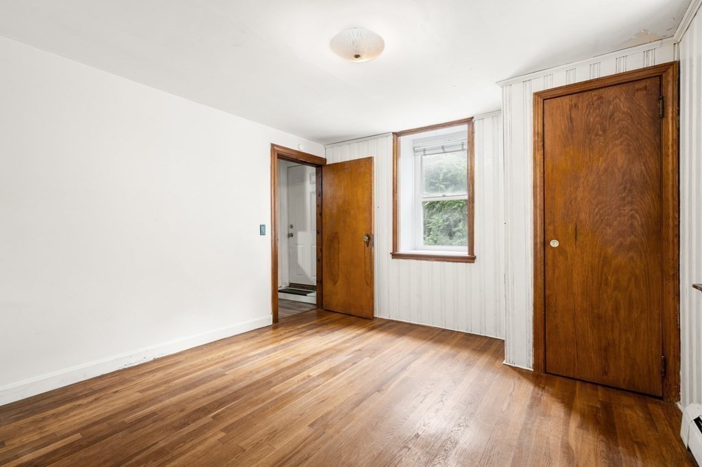 3 Wilson Street Worcester, MA 01604 - Photo 29 of 42 an empty room with wooden floor and windows