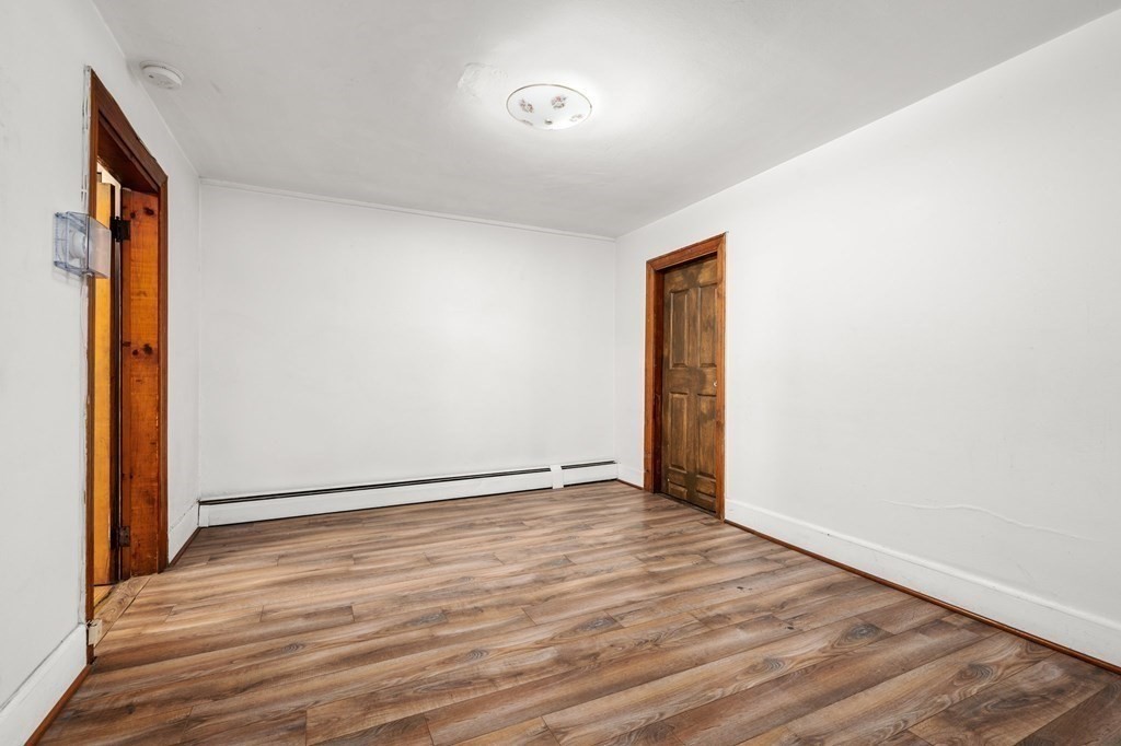 3 Wilson Street Worcester, MA 01604 - Photo 30 of 42 a view of an empty room with wooden floor and a window