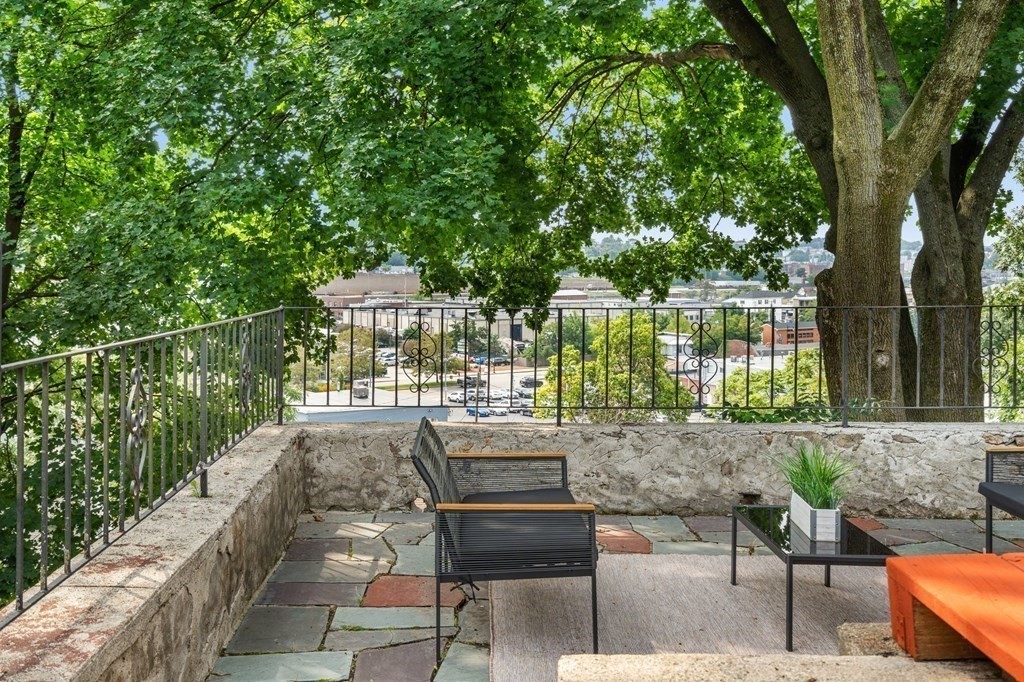 3 Wilson Street Worcester, MA 01604 - Photo 3 of 42 a view of a patio with couches table and chairs and potted plants