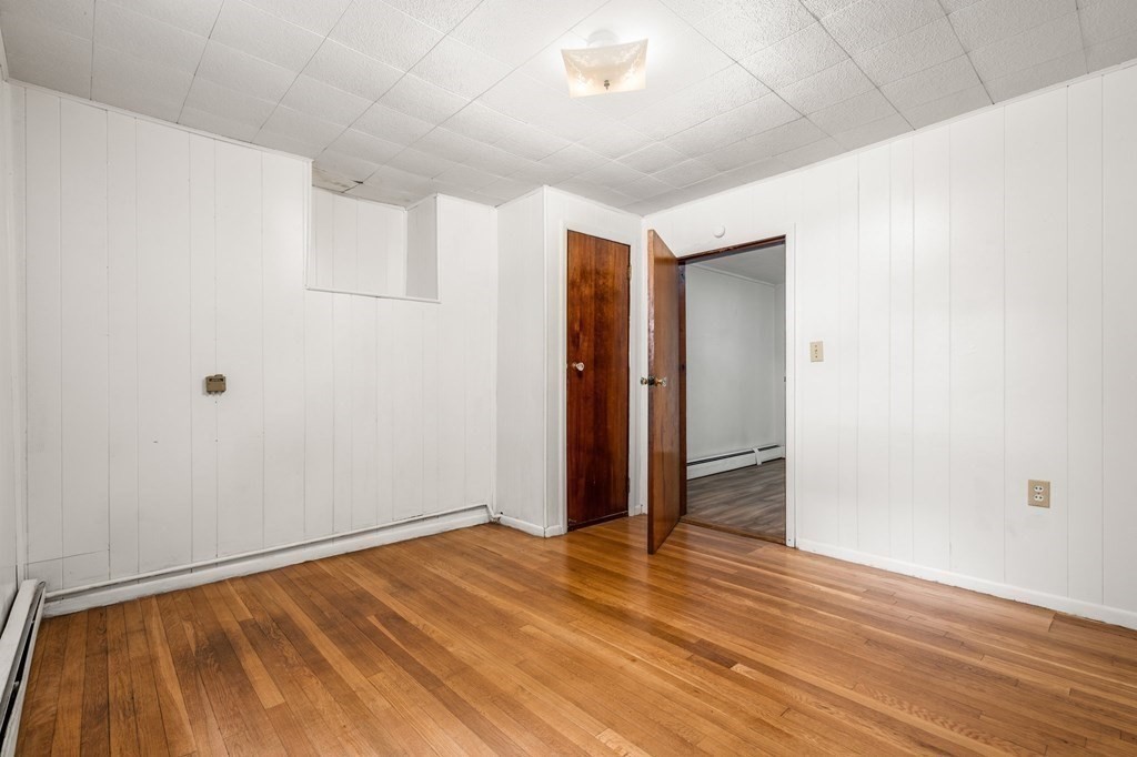 3 Wilson Street Worcester, MA 01604 - Photo 32 of 42 an empty room with wooden floor and closet