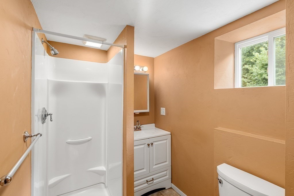 3 Wilson Street Worcester, MA 01604 - Photo 33 of 42 a bathroom with a sink a toilet a shower and a window