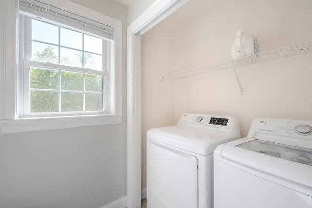 a view of storage and utility room with washer and dryer