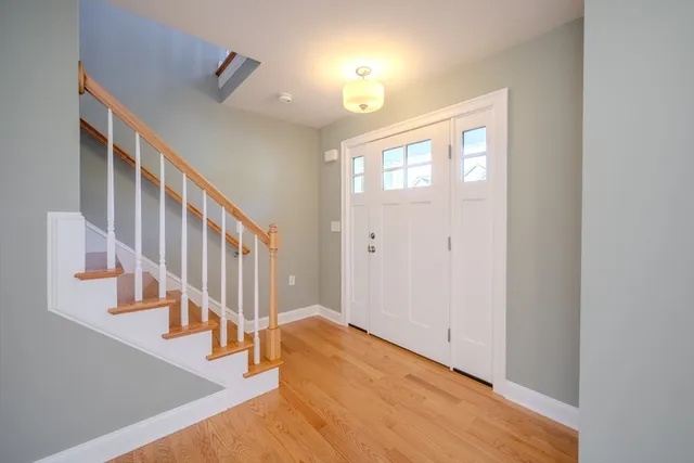 a view of an entryway with wooden floor