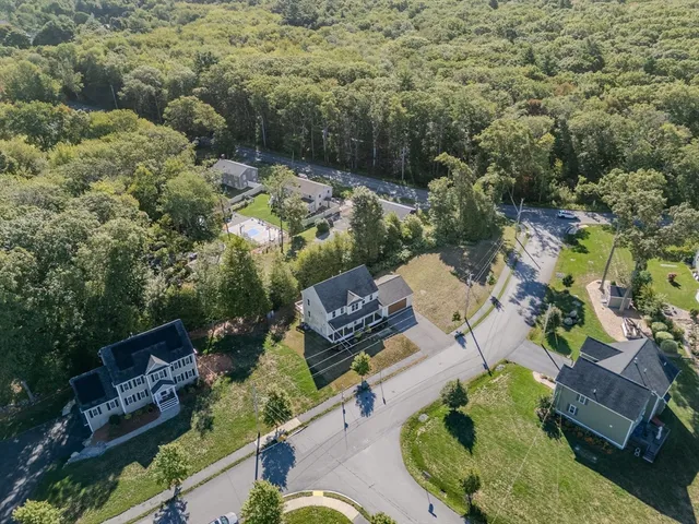 an aerial view of a house with a yard