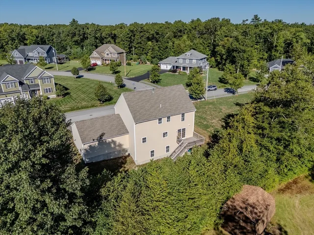 an aerial view of a house with a yard