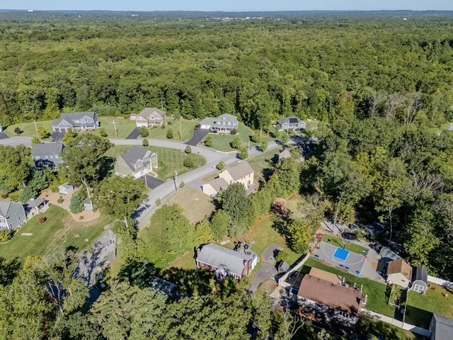 an aerial view of a houses with a yard