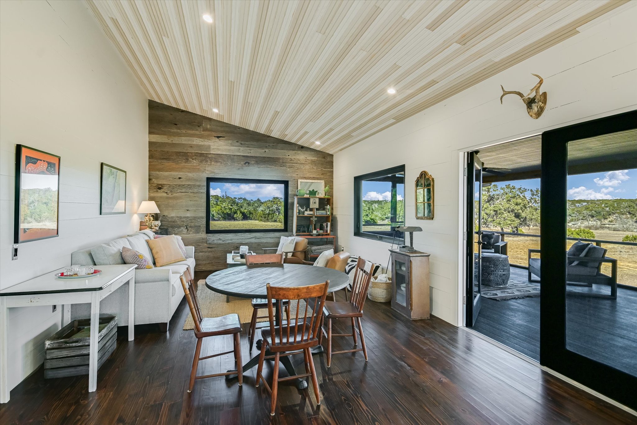 4698 Fischer Store Road Wimberley, TX 78676 - Photo 9 of 28 Gleaming hardwood floors and an angled tongue-and-groove ceiling define this versatile living space.