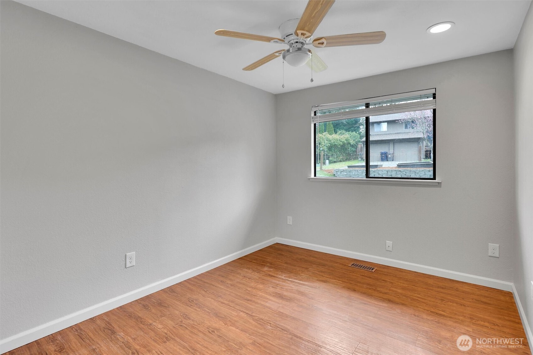 16825 17th Avenue Southeast Bothell, WA 98012 - Photo 18 of 37 an empty room with wooden floor chandelier fan and windows