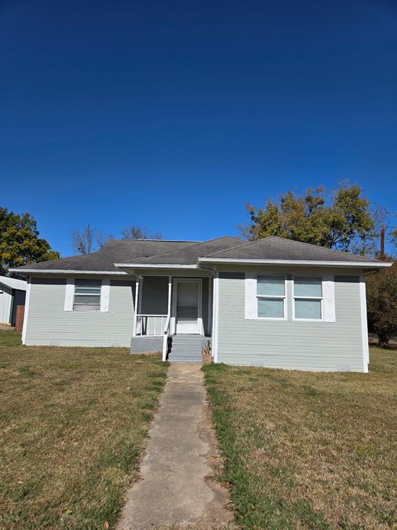 1145 Jefferson Road Paris, TX 75460 - Photo 14 of 14 a front view of a house with a yard