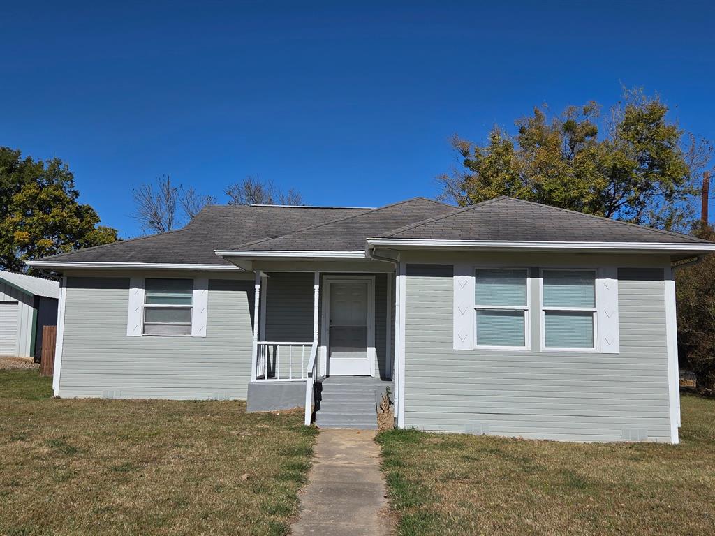 1145 Jefferson Road Paris, TX 75460 - Photo 2 of 14 a front view of a house with a yard
