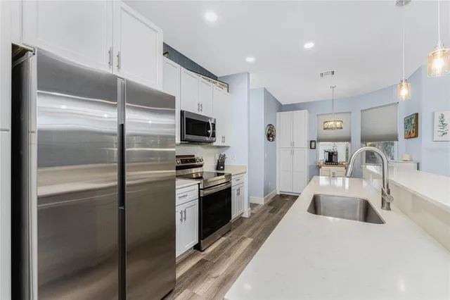 a kitchen with a sink stove and microwave