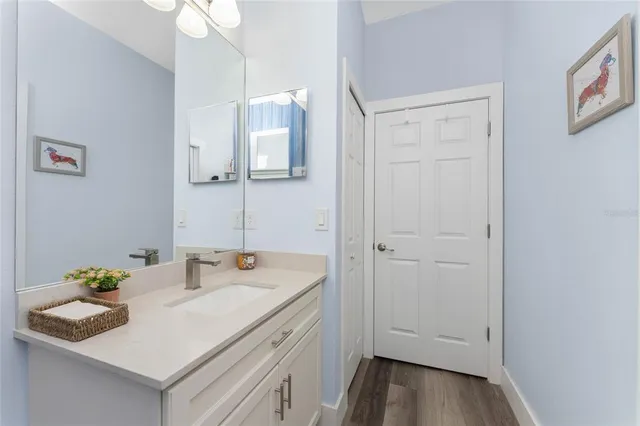 a view of backyard with swimming pool and brick wall