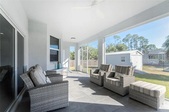 a view of a house with backyard and trees