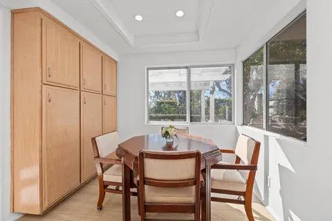 a dining room with furniture and window