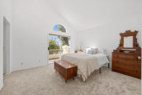 a spacious bedroom with a bed and a window