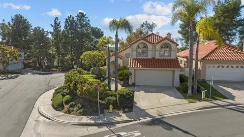 a view of a house with a fountain in a yard