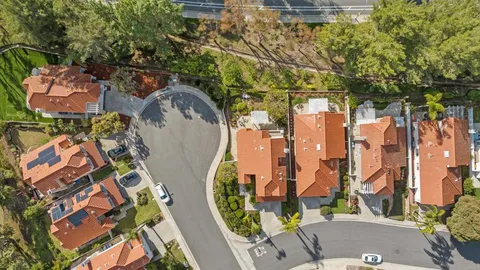 an aerial view of residential house with outdoor space and trees
