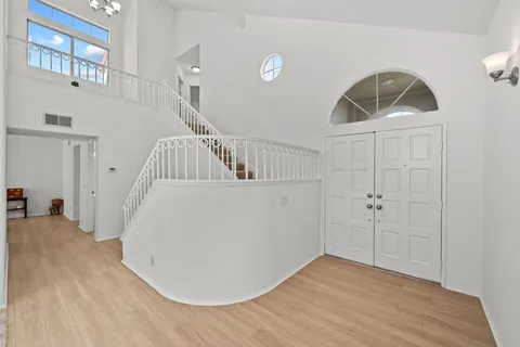 a view of entryway and hall with wooden floor