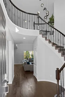a hallway with wooden floor and furniture