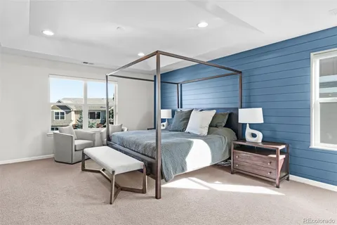 a spacious bedroom with a bed and a couch