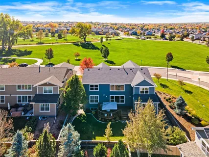 an aerial view of a house with a garden and lake view