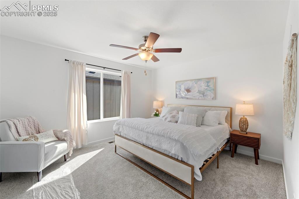 1920 Erin Loop Colorado Springs, CO 80918 - Photo 13 of 26 a bedroom with a bed couch and a window