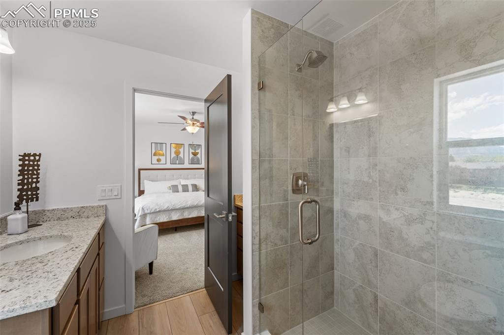 1920 Erin Loop Colorado Springs, CO 80918 - Photo 15 of 26 a bathroom with a granite countertop shower mirror and a sink