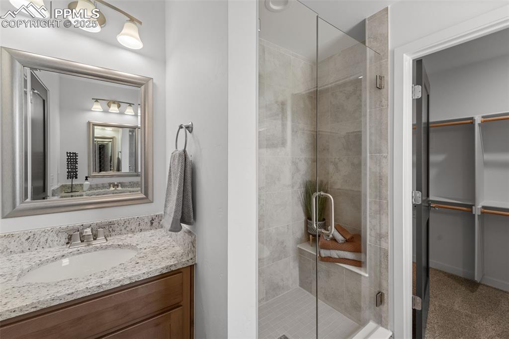 1920 Erin Loop Colorado Springs, CO 80918 - Photo 17 of 26 a bathroom with a granite countertop sink and a mirror