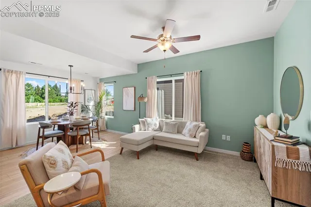 a living room with furniture and a large window