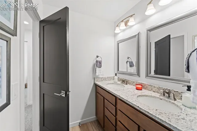 a bathroom with a granite countertop sink double and mirror
