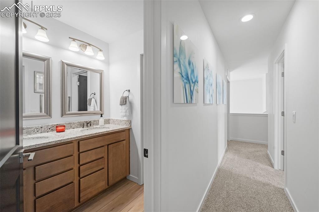 1920 Erin Loop Colorado Springs, CO 80918 - Photo 23 of 26 a bathroom with a double vanity sink and mirror