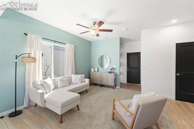 a living room with furniture and a chandelier