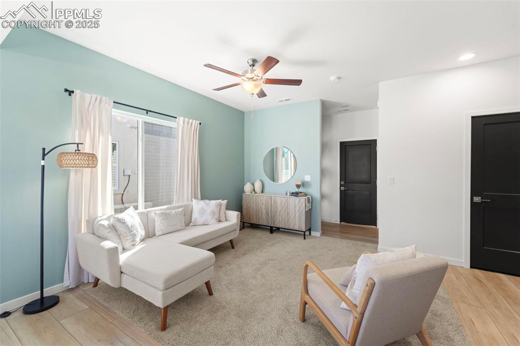 1920 Erin Loop Colorado Springs, CO 80918 - Photo 3 of 26 a living room with furniture and a chandelier