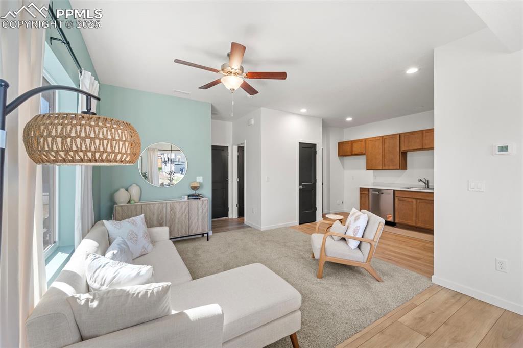 1920 Erin Loop Colorado Springs, CO 80918 - Photo 4 of 26 a living room with furniture and a chandelier