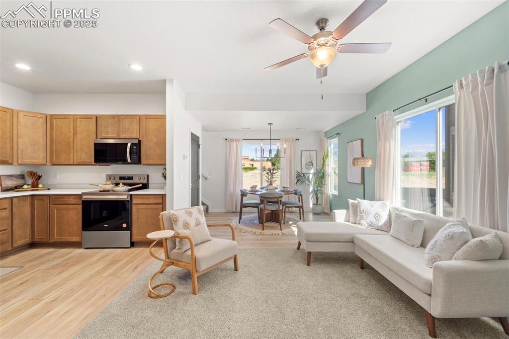1920 Erin Loop Colorado Springs, CO 80918 - Photo 5 of 26 a living room with furniture white walls and kitchen view