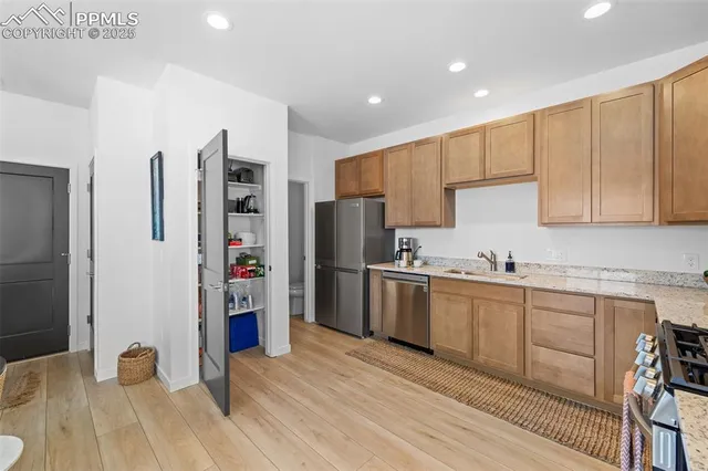 a kitchen with stainless steel appliances a refrigerator sink and cabinets