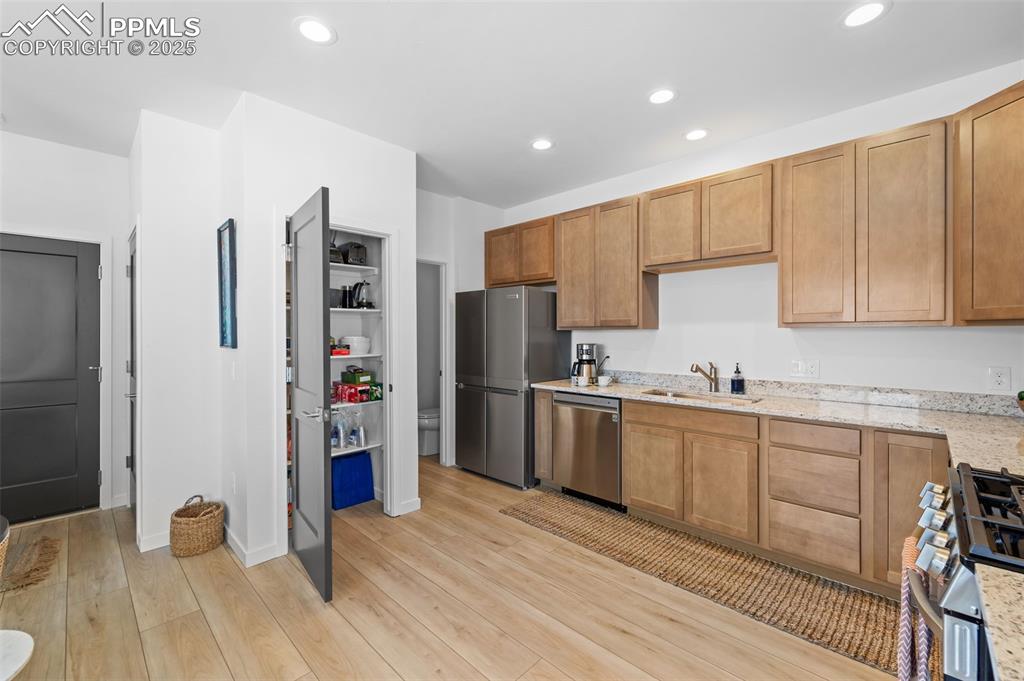 1920 Erin Loop Colorado Springs, CO 80918 - Photo 9 of 26 a kitchen with stainless steel appliances a refrigerator sink and cabinets