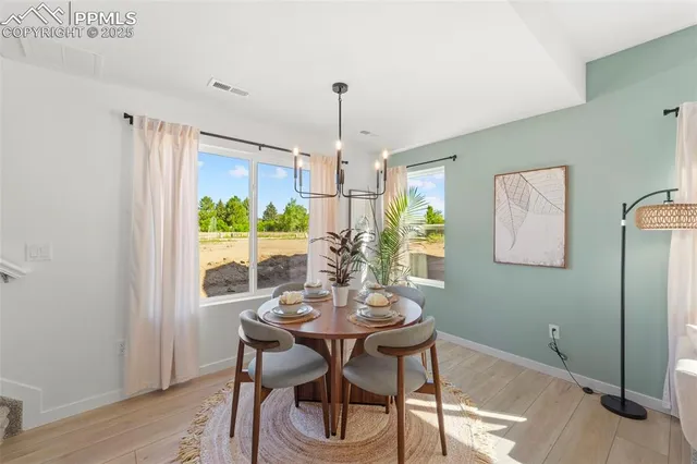 a view of a dining room with furniture window and wooden floor