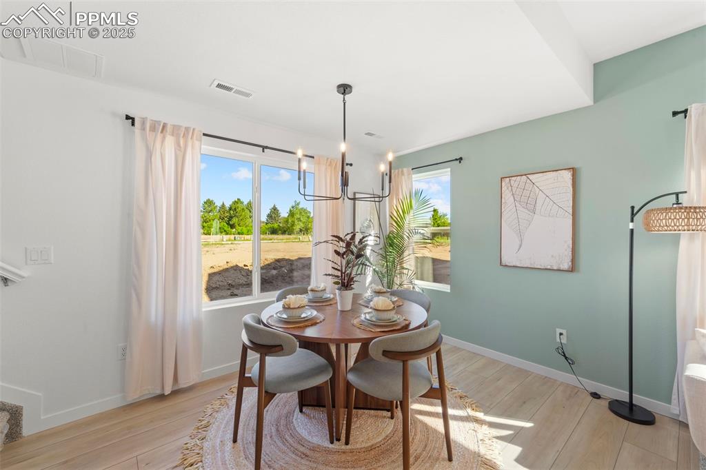 1920 Erin Loop Colorado Springs, CO 80918 - Photo 10 of 26 a view of a dining room with furniture window and wooden floor