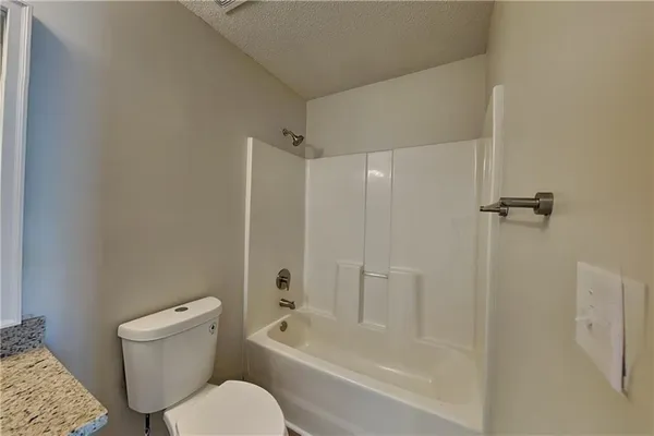 a bathroom with a toilet and a bathtub