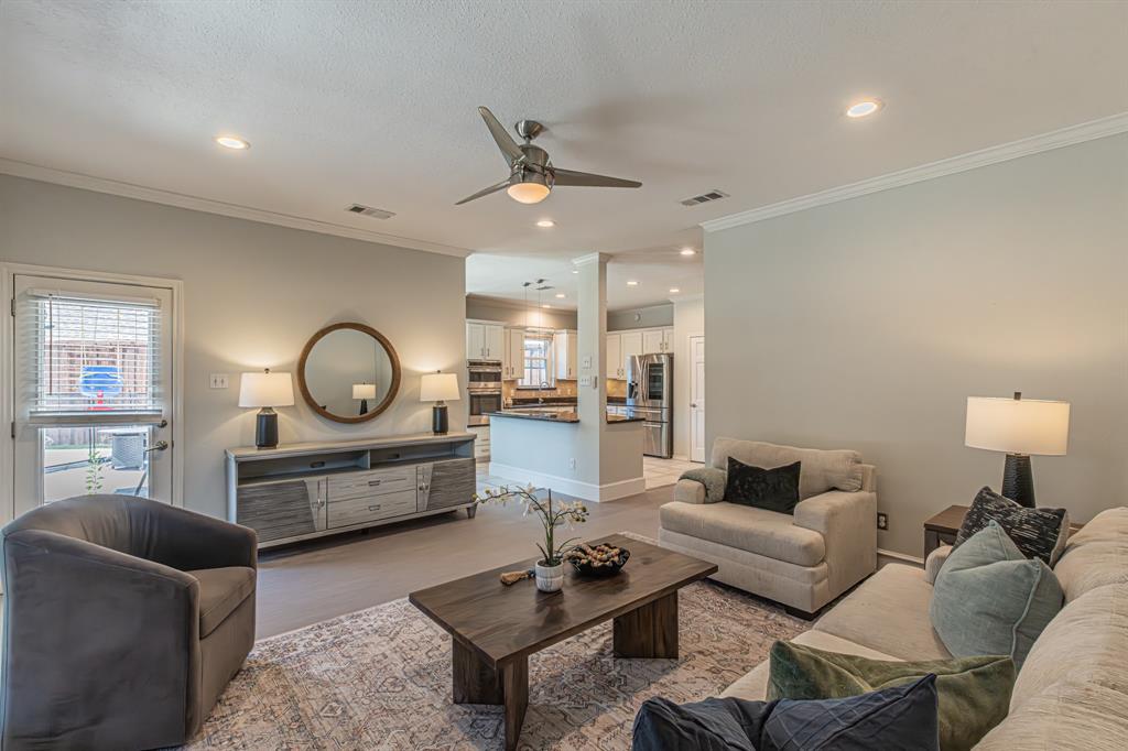 300 Sundance Circle Irving, TX 75063 - Photo 26 of 39 Open-concept living area featuring light gray wall paint, crown molding, a ceiling fan, and recessed lighting