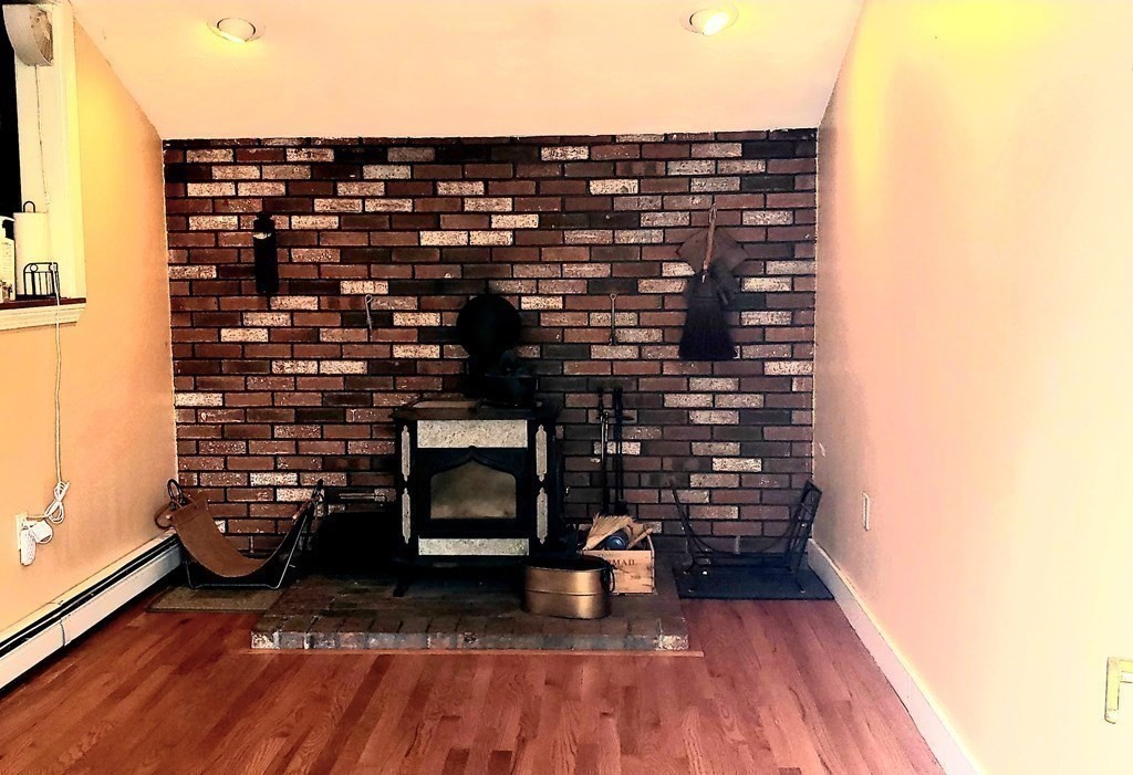 792 Ash Street Brockton, MA 02301 - Photo 25 of 42 a picture of a fireplace with wooden floor