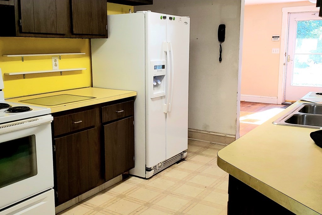 792 Ash Street Brockton, MA 02301 - Photo 26 of 42 a kitchen with a refrigerator and a stove
