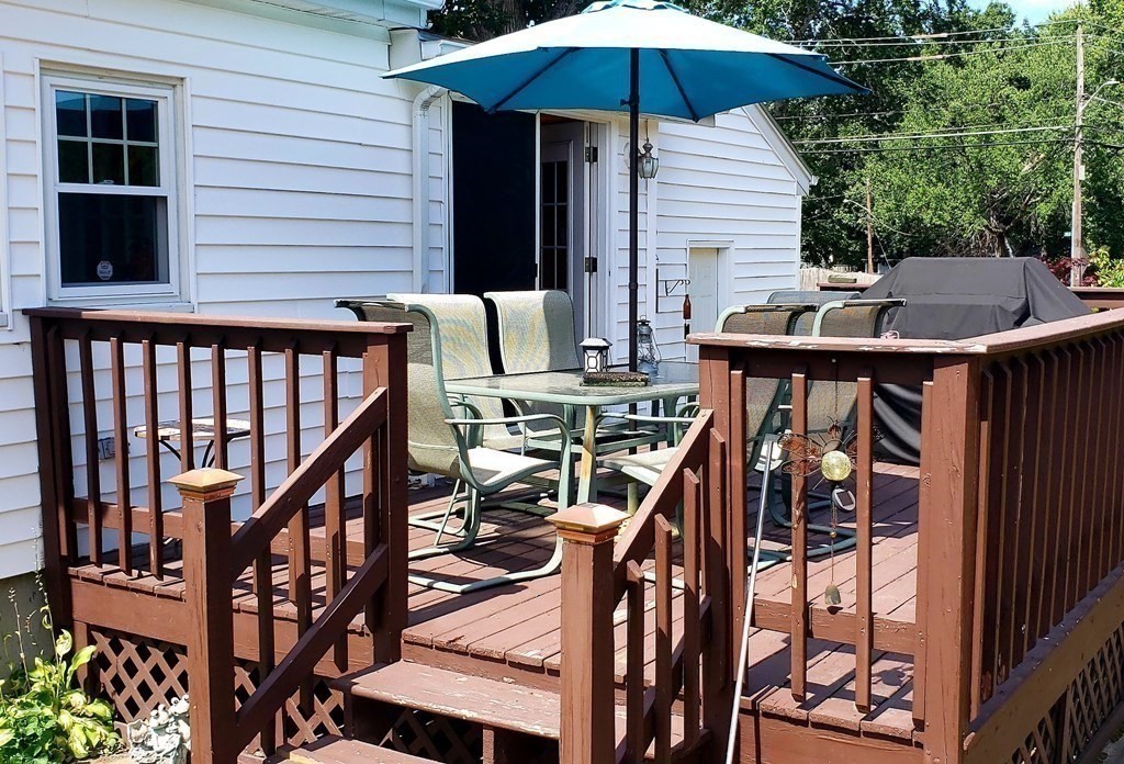 792 Ash Street Brockton, MA 02301 - Photo 28 of 42 a view of a patio with a table and chairs under an umbrella