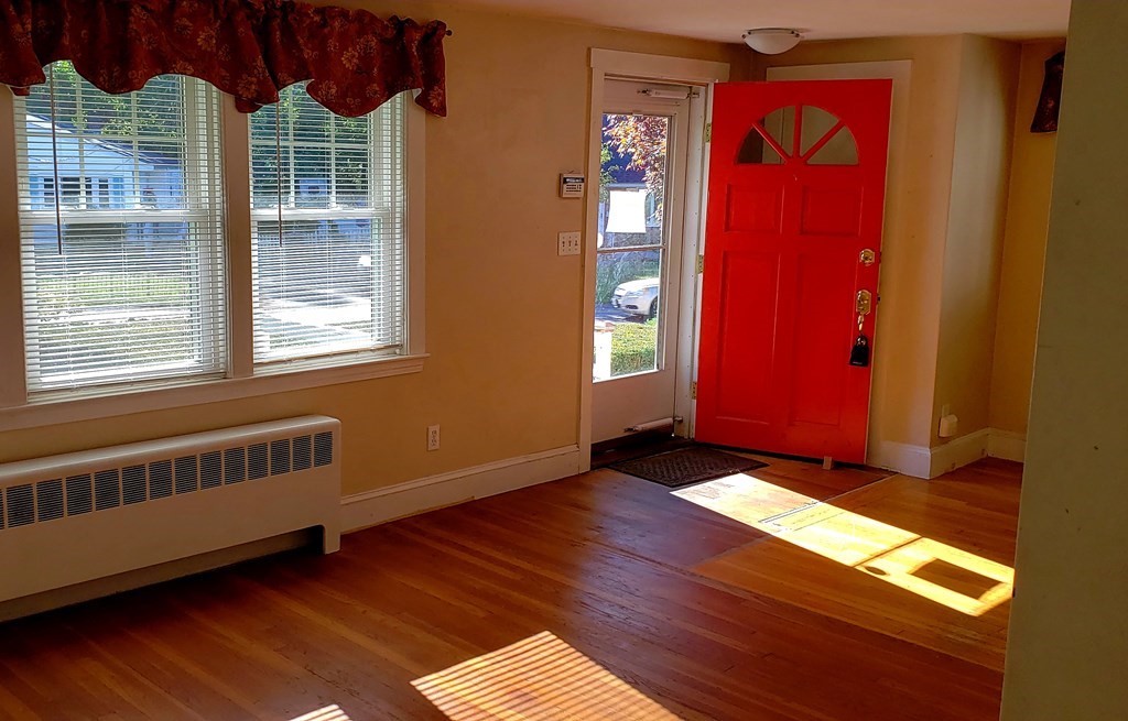 792 Ash Street Brockton, MA 02301 - Photo 29 of 42 a view of an empty room with window wooden floor and front door